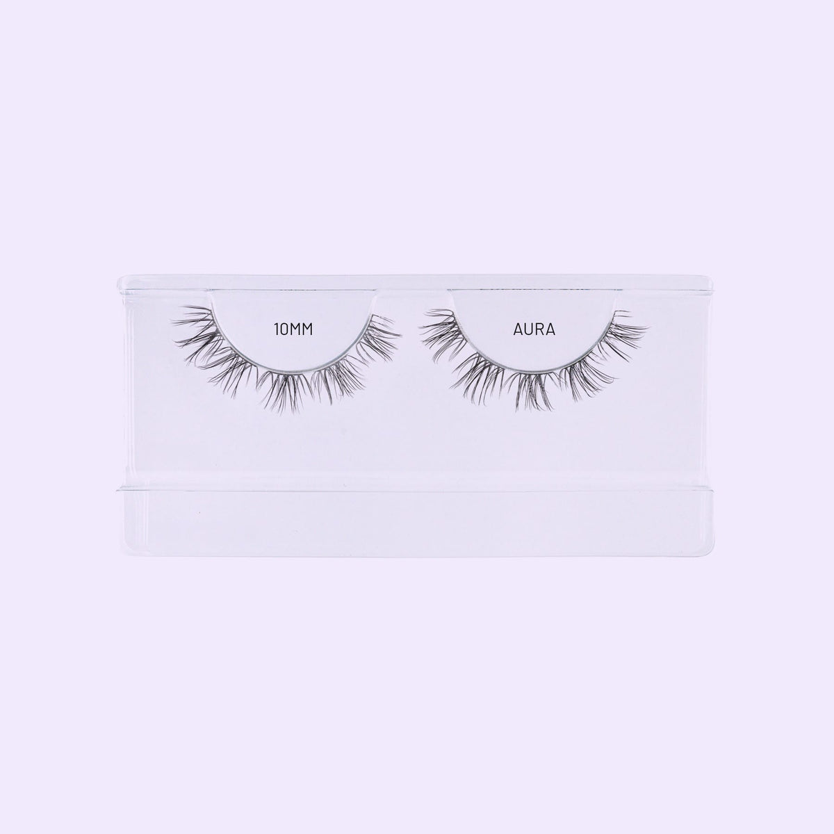 Aura NanoSoft 10mm lash clusters arranged in a clear Lilac St. tray against a soft lilac background.