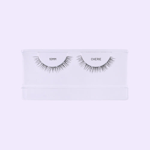 Lilac St. Cherie NanoSoft 10mm lash clusters arranged in a clear tray against a soft lilac background.