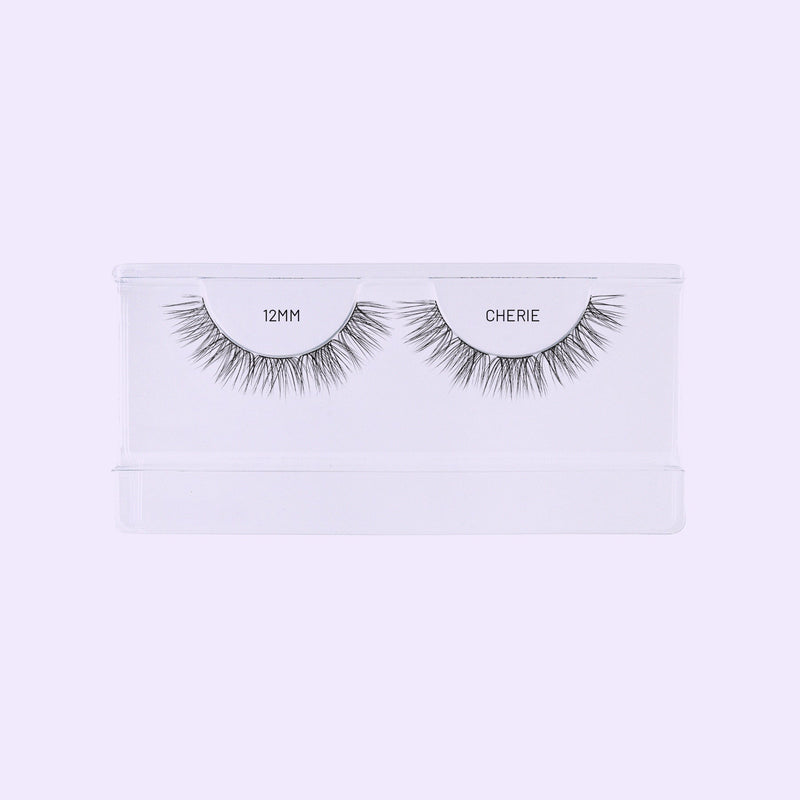 Cherie 12mm NanoSoft lash clusters in a clear Lilac St. tray against a soft lilac background.